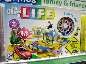 In this Wednesday, Nov. 11, 2015 file photo, the Hasbro board game "The Game of Life" rests on a shelf in a toy store in North Attleboro, Mass. Hasbro is hitting back in a lawsuit from a toy inventor's widow who says her husband invented The Game of Life. In its first response to the lawsuit on Friday, Dec. 18, 2015, Hasbro Inc. denies that toy inventor Bill Markham created or designed the game, and says his widow has no ownership interest in it. The board game is one of the most popular in history.  (AP Photo/Steven Senne, File)