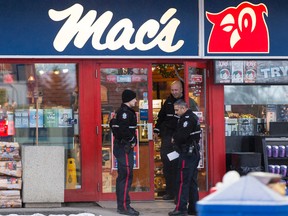 Edmonton Police Service officers investigate a fatal shooting during an armed robbery at a Mac's store at 108 Street and 61 Avenue in Edmonton, Alta., on Friday December 18, 2015.Ian Kucerak/Edmonton Sun