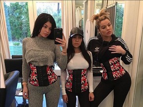 Kylie Jenner, Kourtney Kardashian and Khloe Kardashian pose in waist trainers. (instagram.com/kourtneykardash)
