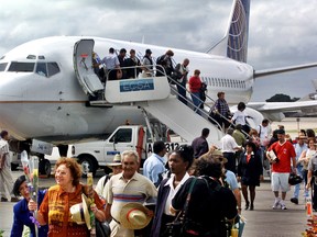 In this Nov. 1, 2001, file photo, the first passengers of the first flight of Continental Airlines from Miami, Florida, arrives at the Jose Marti Airport of Havana, Cuba. (AP Photo/Jose Goitia, File)