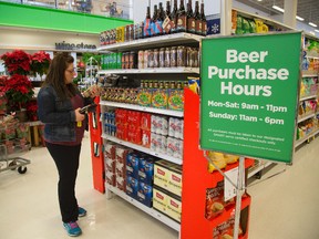 Erin Anderson of London looks over a selection of craft beers at the Oakridge Loblaws Superstore when beer sales began in Ontario grocery stores on Tuesday. (MIKE HENSEN, The London Free Press)