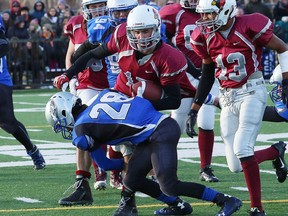 Matt Bell, of St. Charles Cardinals, is tackled by Matt McGregor, of Superior Heights Steelhawks, during NOSSA senior boys football action at James Jerome Sports Complex in Sudbury, Ont. on Saturday November 7, 2015.