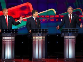 Republican U.S. presidential candidate businessman Donald Trump (L) responds to criticism from former Governor Jeb Bush (R) as Senator Ted Cruz (C) looks on during the Republican presidential debate in Las Vegas, Nevada on December 15, 2015. REUTERS/Mike Blake