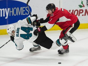 Senators center Kyle Turris pushes San Jose Sharks defenseman Marc-Edouard Vlasic off the puck during first period NHL action Friday December 18, 2015 in Ottawa. 
THE CANADIAN PRESS/Adrian Wyld