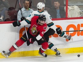 Ottawa Senators defenseman Chris Wideman collides with San Jose Sharks center Joe Thornton along the boards during third period NHL action Friday December 18, 2015 in Ottawa. The Senators defeated the Sharks 4-2. THE CANADIAN PRESS/Adrian Wyld