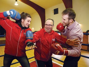 Blue Team coach Amber Konikow, left, Gord Apolloni, of Top Glove Boxing Academy, and Red Team coach Justin Ceskauskas were on hand to promote the launch of Mining Wars in Sudbury, Ont. on Friday December 18, 2015. John Lappa/Sudbury Star/Postmedia Network