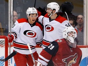 Jeff Skinner (left) and Phil Di Giuseppe of the Hurricanes celebrate a goal against Coyotes netminder Anders Lindback last weekend. (The Associated Press)