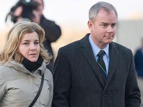 Dennis Oland and his wife Lisa head from the Law Courts as the jury begins their deliberations at his murder trial in Saint John, N.B. on Wednesday, Dec. 16, 2015. Oland is charged with second degree murder in the death of his father, Richard Oland, who was found dead in his Saint John office on July 7, 2011. (The Canadian Press/Andrew Vaughan)