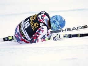 Matthias Mayer lies on the snow after crashing during the men’s downhill race at the World Cup in Val Gardena, Italy, December 19, 2015. (REUTERS/Alessandro Garofalo)