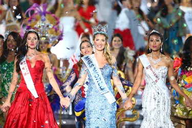Miss World Mireia Lalaguna Royo from Spain, center, Sofia Nikitchuk from Russia, left, the runner-up, and Maria Harfanti from Indonesia, right, the second runner-up celebrate at the end of the 2015 Miss World Grand Final in Sanya in south China's Hainan province Saturday Dec. 19, 2015. Spain's Mireia Lalaguna Royo was named the winner of the Miss World 2015 competition Saturday night in the southern Chinese island resort of Sanya, an event dogged by controversy over China's refusal to allow Canada's entrant to attend. (Chinatopix Via AP)