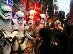 Fans dressed as Star Wars characters parade outside a movie theater showing "Star Wars: The Force Awakens" Saturday, Dec. 19, 2015, in Taipei, Taiwan. (AP Photo/Chiang Ying-ying)