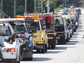Tow truck operators gathered together Sunday, Aug.30, 2015, in support of Abbas Kadir, the owner of Jonny's Towing who was critically injured last week while responding to a call on Highway 417. They also wanted to raise awareness for the changes to the move-over law which come into effect Monday.
MATT DAY/OTTAWA SUN