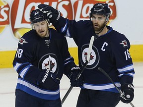 Winnipeg Jets Andrew Ladd (right) celebrates his empty-net goal against the New York Rangers with Bryan Little in Winnipeg on Fri., Dec. 18, 2015. Kevin King/Winnipeg Sun/Postmedia Network