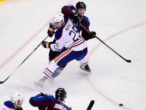 Dec 19, 2015; Denver, CO, USA; Edmonton Oilers defenseman Darnell Nurse (25) stops an attempt on goal by Colorado Avalanche center Matt Duchene (9) in the first period at the Pepsi Center. Mandatory Credit: Ron Chenoy-USA TODAY Sports