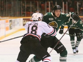 The Owen Sound Attack's Marcus Phillips, left, takes the body of London Knights' Cliff Pu as Pu battles to get around Phillips to regain control of the puck during Ontario Hockey League first period action at the Lumley Bayshore in Owen Sound, Ont. on Saturday, December 19, 2015.  James Masters/Owen Sound Sun TimesPost Media Network