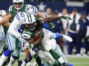 New York Jets running back Chris Ivory (33) is tackled by Dallas Cowboys' Greg Hardy (76) and  Demarcus Lawrence (90) during the first half of an NFL football game Saturday, Dec. 19, 2015, in Arlington, Texas. (Jose Yau/Waco Tribune Herald via AP)