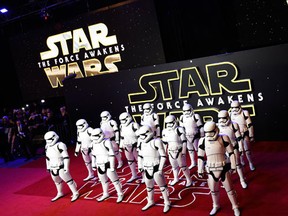 Characters in costume pose for photographers at the European Premiere of Star Wars, The Force Awakens in Leicester Square, London, in this file photo taken December 16, 2015. "Star Wars: The Force Awakens" hauled in an estimated $250 million at global movie box offices through Friday and was on track to finish its opening weekend with record U.S. and Canadian ticket sales, Walt Disney Co said on Saturday. (REUTERS/Dylan Martinez/Files)