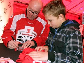 Former NHL player and Sarnia native Mike Stapleton signs an autograph for Ty Desjardine, 13, of Sarnia during the Rogers Hometown Hockey Tour (on Saturday, Dec. 19, 2015 in Sarnia, Ont.) Stapleton was one of several NHL alumni with local ties who appeared at the event. Terry Bridge/Sarnia Observer/Postmedia Network