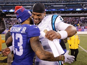 Carolina Panthers' Cam Newton, right, hugs New York Giants' Odell Beckham (13) after an NFL football game Sunday, Dec. 20, 2015, in East Rutherford, N.J. The Panthers won 38-35. (AP Photo/Peter Morgan)