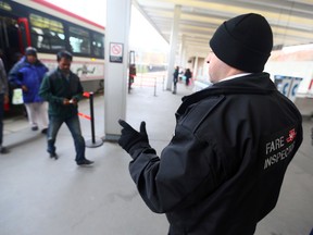 TTC fare inspector Darryl Gauci checks tickets at Bathurst station on Friday, December 18, 2015. (Dave Abel/Toronto Sun)