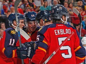 Florida Panthers forward Jaromir Jagr (68) is congratulated by forward Aleksander Barkov (16) and forward Jonathan Huberdeau (11) after scoring the go-ahead goal during the first period of an NHL hockey game against the Vancouver Canucks, Sunday, Dec. 20, 2015, in Sunrise, Fla. (AP Photo/Joel Auerbach)