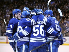 Toronto Maple Leafs center Byron Froese (56) is congratulated by teammates on his first career goal in the third period against the Los Angeles Kings at Air Canada Centre. The Maple Leafs beat the Kings 5-0. Tom Szczerbowski-USA TODAY Sports