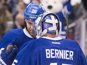 Toronto Maple Leafs' Daniel Winnik hands goaltender Jonathan Bernier the game puck after he shut out Los Angeles Kings during his team's 5-0 win in NHL hockey action in Toronto on Saturday December 19, 2015. THE CANADIAN PRESS/Chris Young