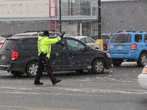 John Lappa/Sudbury Star
A Greater Sudbury Police officer controls the flow of traffic at an entrance to the New Sudbury Centre on Saturday.