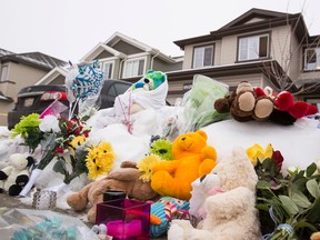 A memorial is seen for seven members of a family slain Dec. 30, 2014 outside of a home near 180A Avenue and 83 Street in Edmonton. The killer, 53-year-old Phu Lam, committed suicide inside a Fort Saskatchewan restaurant. (Edmonton Sun file)