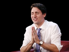 Prime Minister Justin Trudeau reacts during a Maclean's magazine town hall in Ottawa, Canada, December 16, 2015. REUTERS/Chris Wattie