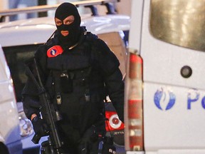 A Belgian special forces police officer patrols a street during a police raid in central Brussels, Belgium, Dec. 20, 2015, which, according to Belgian media, is in connection with last month's deadly Paris attack.   REUTERS/Yves Herman