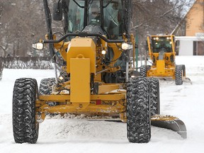 Crews clear snow on Magnus Avenue during a residential ploughing operation on Sunday. (Brian Donogh/Winnipeg Sun)