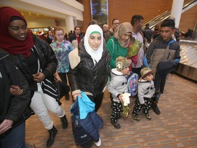 Members of the Daas family collect their luggage in Winnipeg on Saturday. The family and other Syrian refugees met local politicians on Monday as part of an official welcome to the city. (FILE PHOTO)