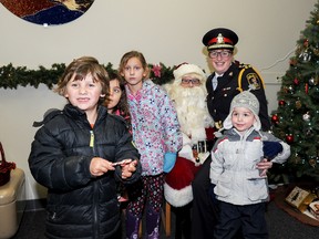 Don Carr/Special to The Intelligencer
Police Chief Cory MacKay and Santa Claus wished children a merry Christmas during the recent Children’s Safety Village festive celebration.