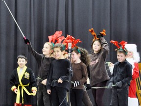 Bryce Otten, as one of Santa’s reindeers, whips out his selfie stick so the reindeer could take advantage of the photo op during the Grade 3 class performance of T’was the Night Before Christmas poem. ANDY BADER/MITCHELL ADVOCATE