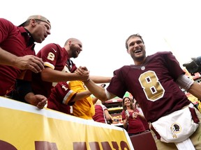 Quarterback Kirk Cousins #8 of the Washington Redskins celebrates with fans after defeating the Tampa Bay Buccaneers 31-30 during a game at FedExField on October 25, 2015 in Landover, Maryland.   Matt Hazlett/Getty Images/AFP