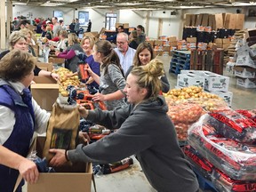 More than 140 volunteers help pack more than 2,000 Christmas hampers in record time for the Jerome Taylor Memorial/Whig-Standard Salvation Army Christmas Hamper Campaign at Portsmouth Olympic Harbour on Monday.