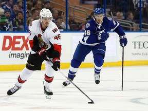 Ottawa Senators defenceman Patrick Wiercioch (46) controls the pucks ahead of Tampa Bay Lightning right wing Michael Blunden (46) during the second period of an NHL hockey game, Sunday, Dec. 20, 2015, in Tampa, Fla. (AP Photo/Brian Blanco)