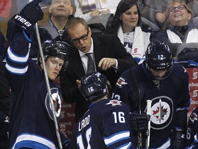 Jets coach Paul Maurice talks to captain Andrew Ladd on the bench earlier this season. Maurice demoted Ladd to the third line last Friday night after the captain took a bad penalty. Maybe more of that is needed to finally get the Jets to play with discipline.