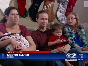 Kristin Allred, left, is pictured with her husband, Shay, and their children after Allred gave birth to her 8.4-pound baby girl, Anne, in the family truck. (kutv.com screengrab)