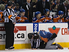 Linesman Devin Berg had to leave the game briefly after taking a hit against the boards from Oilers defenceman Nikita Nikitin. (Codie McaLachlan, Edmonton Sun)