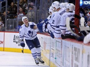 Toronto Maple Leafs center Leo Komarov celebrates with teammates after scoring during the second period against the Colorado Avalanche at Pepsi Center. (Chris Humphreys/USA TODAY Sports)
