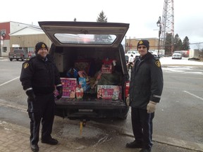 Auxiliary Constable Jonathan Thomas (left) and Auxiliary Staff Sergeant Ralph Johnson were on hand to gather toys for their Stuff a Cruiser Event at Giant Tiger. Auxiliary Constables Ashley Malherbe and Lisa Gauthier were accepting toys at Canadian Tire.