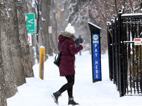 Pedestrians walk through the snow on 109 st and 83 ave in Edmonton, Alberta on December 11, 2015.  Perry Mah /Edmonton Sun/Postmedia Network
