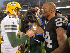 Green Bay Packers quarterback Aaron Rodgers (12) and Oakland Raiders free safety Charles Woodson (24) shake hands after an NFL football game at O.co Coliseum. The Packers defeated the Raiders 30-20. Kirby Lee-USA TODAY Sports