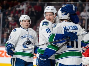 Jared McCann #91 of the Vancouver Canucks celebrates his goal with teammate Jake Virtanen #18 during the NHL game against the Montreal Canadiens at the Bell Centre on November 16, 2015 in Montreal, Quebec, Canada.   Minas Panagiotakis/Getty Images/AFP