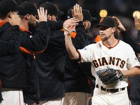 San Francisco Giants starting pitcher Mike Leake (13) high fives team mates after defeating the Los Angeles Dodgers 5-0 at AT&T Park. Ed Szczepanski-USA TODAY Sports