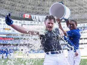 Toronto Blue Jays' Josh Donaldson gets a shower from Ben Revere after hitting a walk-off home run against the Tampa Bay Rays in Toronto on Sept. 27, 2015. (THE CANADIAN PRESS/Frank Gunn)