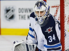 Winnipeg Jets goaltender Michael Hutchinson (34) watches the puck against the Edmonton Oilers during the second period at Rexall Place.