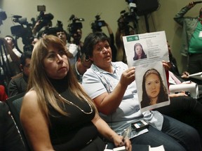 A relative of a missing person holds a photo during a news conference of the members of the Inter-American Commission on Human Rights (IACHR) in Mexico City October 2, 2015. IACHR officials visited the site of mass graves in Mexico's violence-ravaged city of Iguala, discovered during the search for 43 students feared massacred. The disappearance of the students on the night of September 26, 2014 in the southwestern city of Iguala sent shockwaves through Mexico and the world and shone a spotlight on reported human rights abuses in Mexico. (REUTERS/Edgard Garrido)